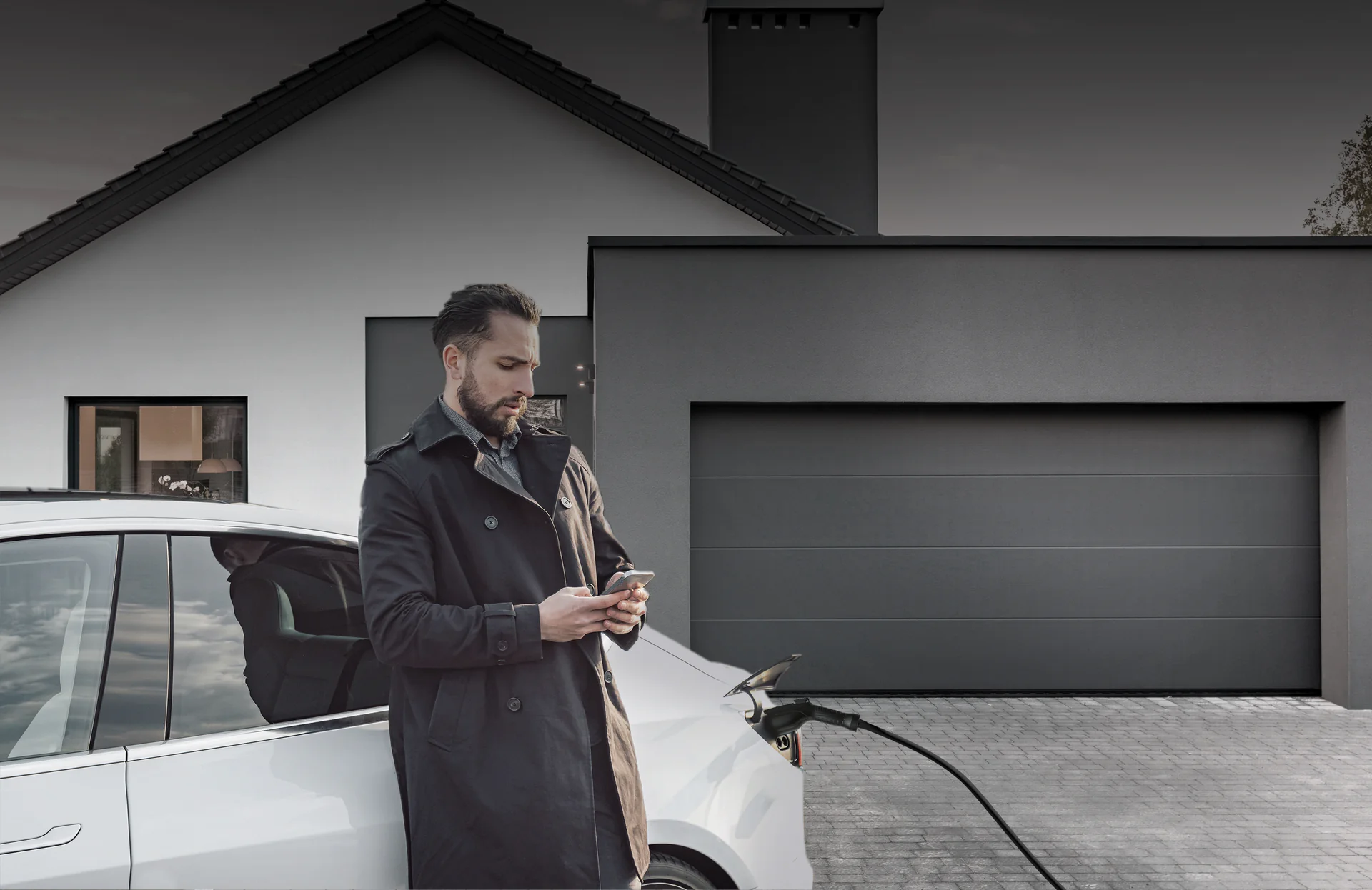 Man charging EV at home with Pion Power Flex-AC Level 2 charger, delivering up to 40A/9.6kW for overnight full charging peace of mind.